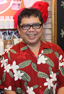 A bespectacled man with a round face