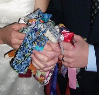 An example of a modern handfasting knot where each wedding guest has tied a ribbon around the clasped hands of the couple.