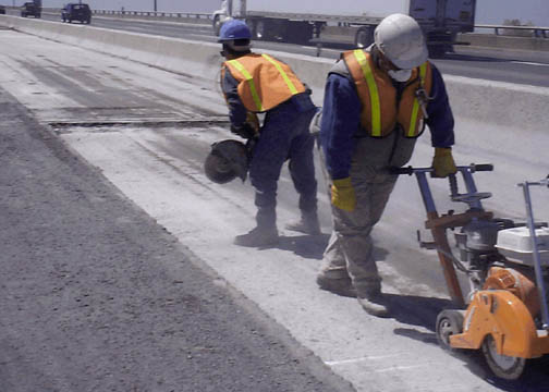 File:Highway construction workers using concrete saws (9245787233).jpg