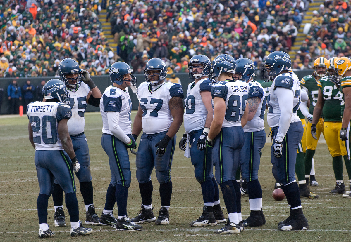 The Seattle Seahawks huddle during an NFL football game against