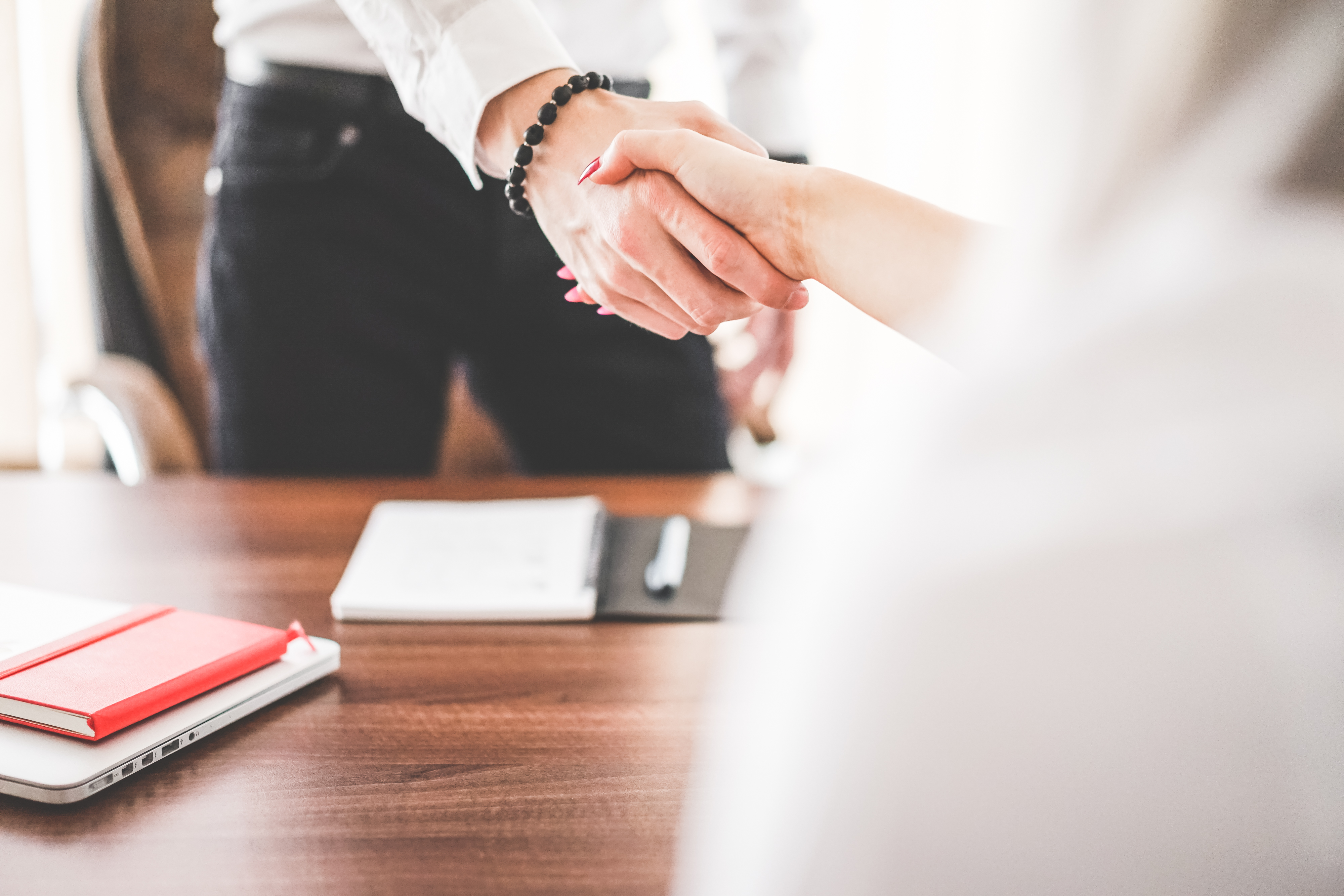 Business man and woman handshake in work office.jpg