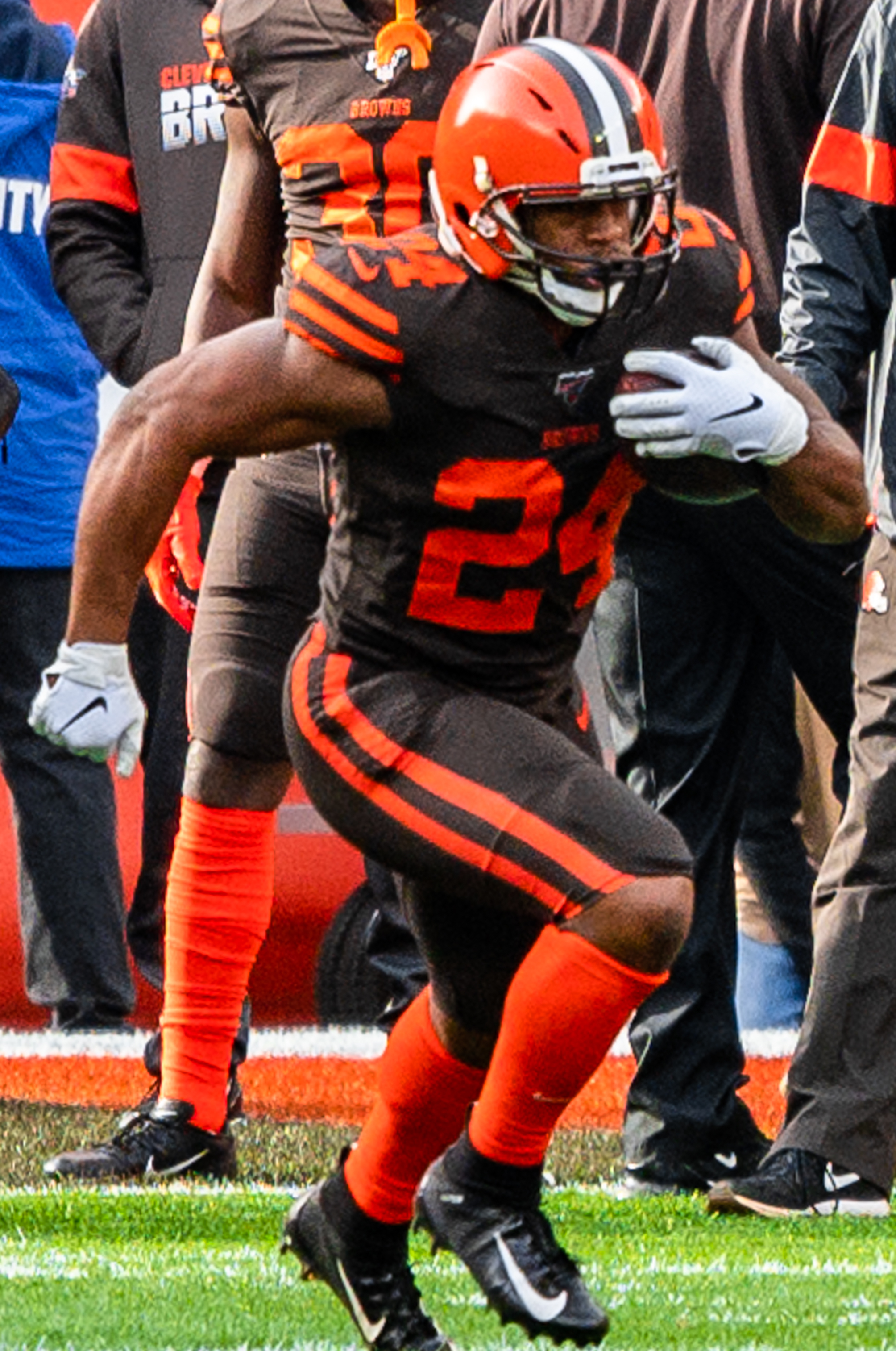 Cleveland Browns Nick Chubb Unsigned Brown Jersey Carrying Ball Photograph