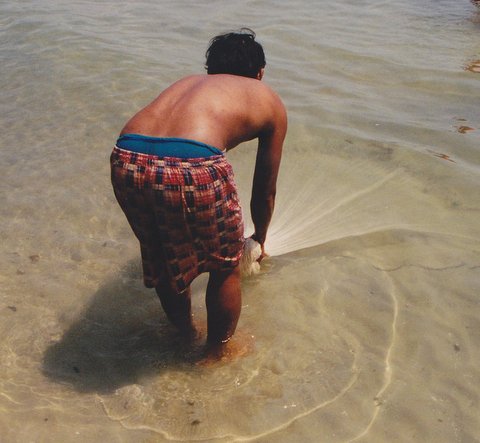 File:Man with a net in Thailand on the beach.jpg