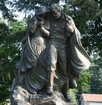 Statue at the Mormon Pioneer Cemetery depicting a man and woman at the grave of their child Statue in Winter Quarters--a memorial to the pioneers who died.jpg