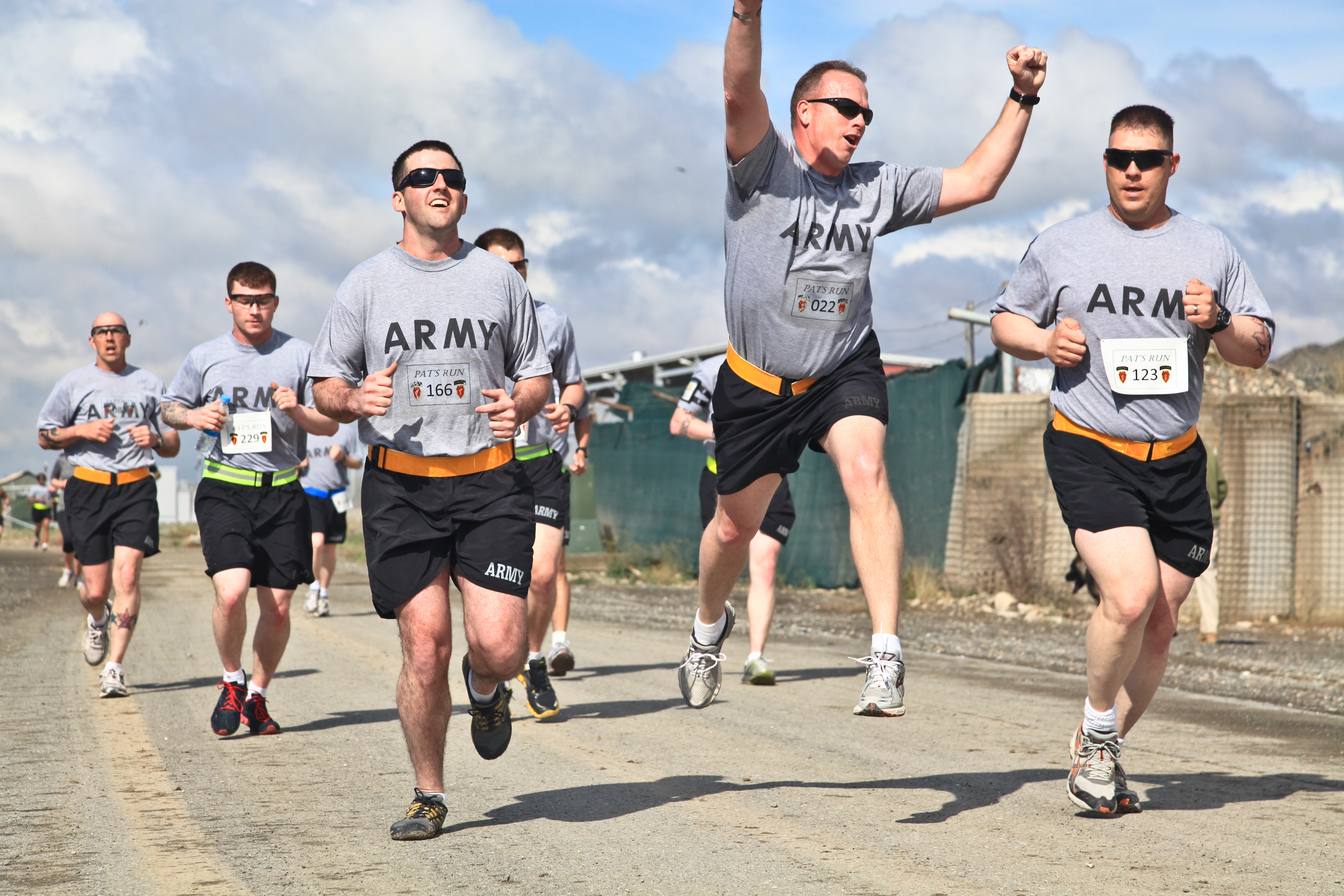 Reg run. Pat Tillman Foundation t Shirt. Pat Cleveland Running on the Beach.