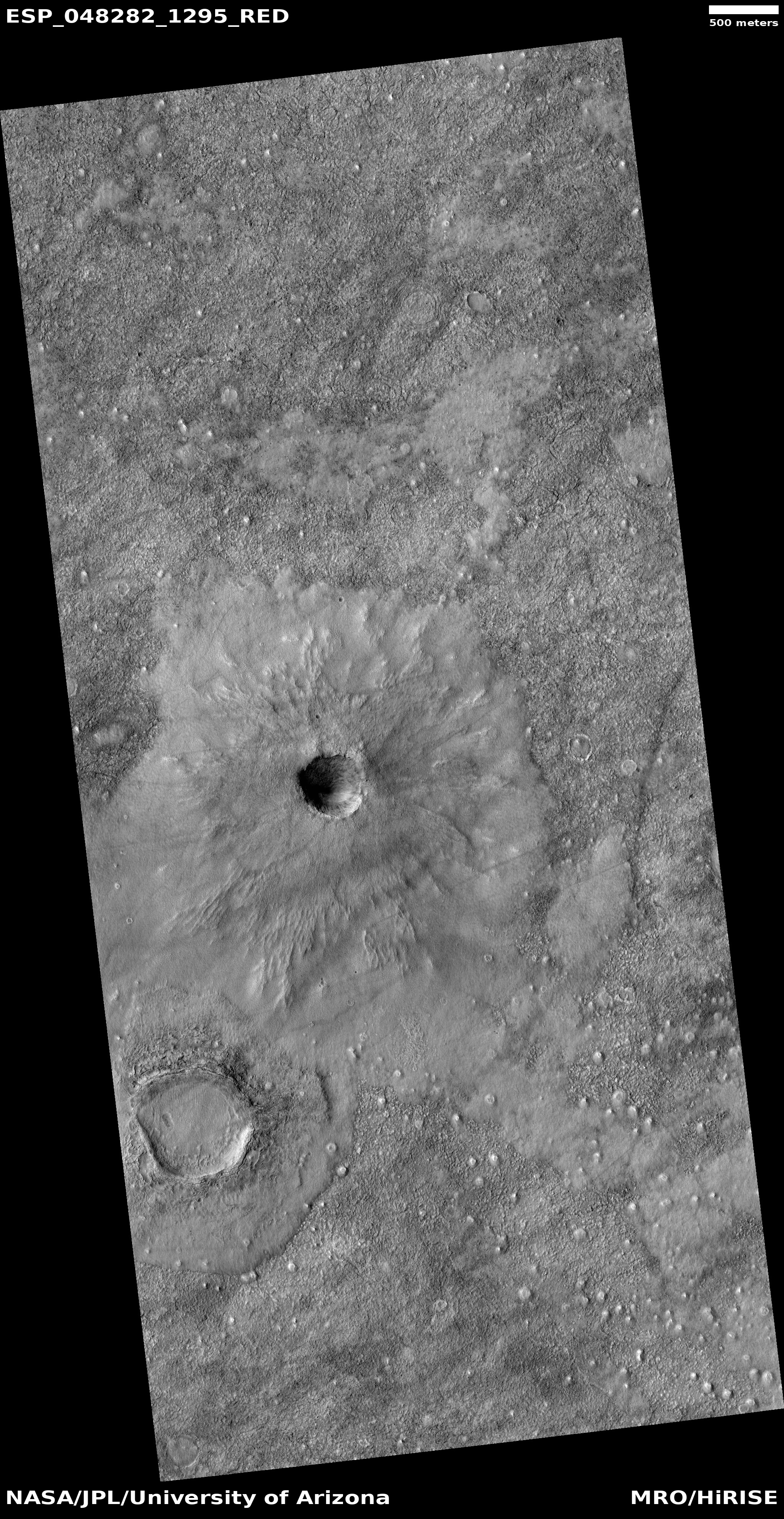 Unnamed crater with thin ejecta There are also many cones visible in the image.