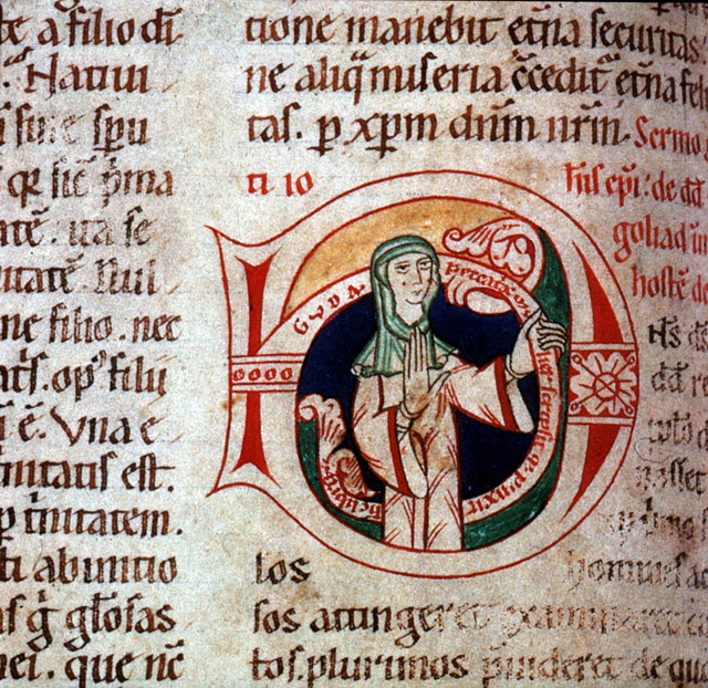 Latin manuscript centered on illuminated letter in green, black, and red