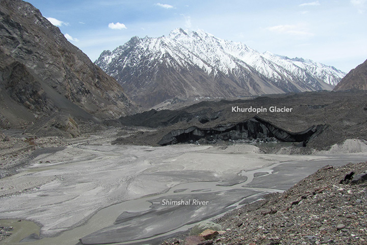 Khurdopin glacier and Shimshal River, Gilgit-Baltistan, northern Pakistan 2017. Several glaciers flow into the Shimshal Valley, and are prone to blocking the river.  Khurdopin glacier surged in 2016–17, creating a sizable lake.[2]
