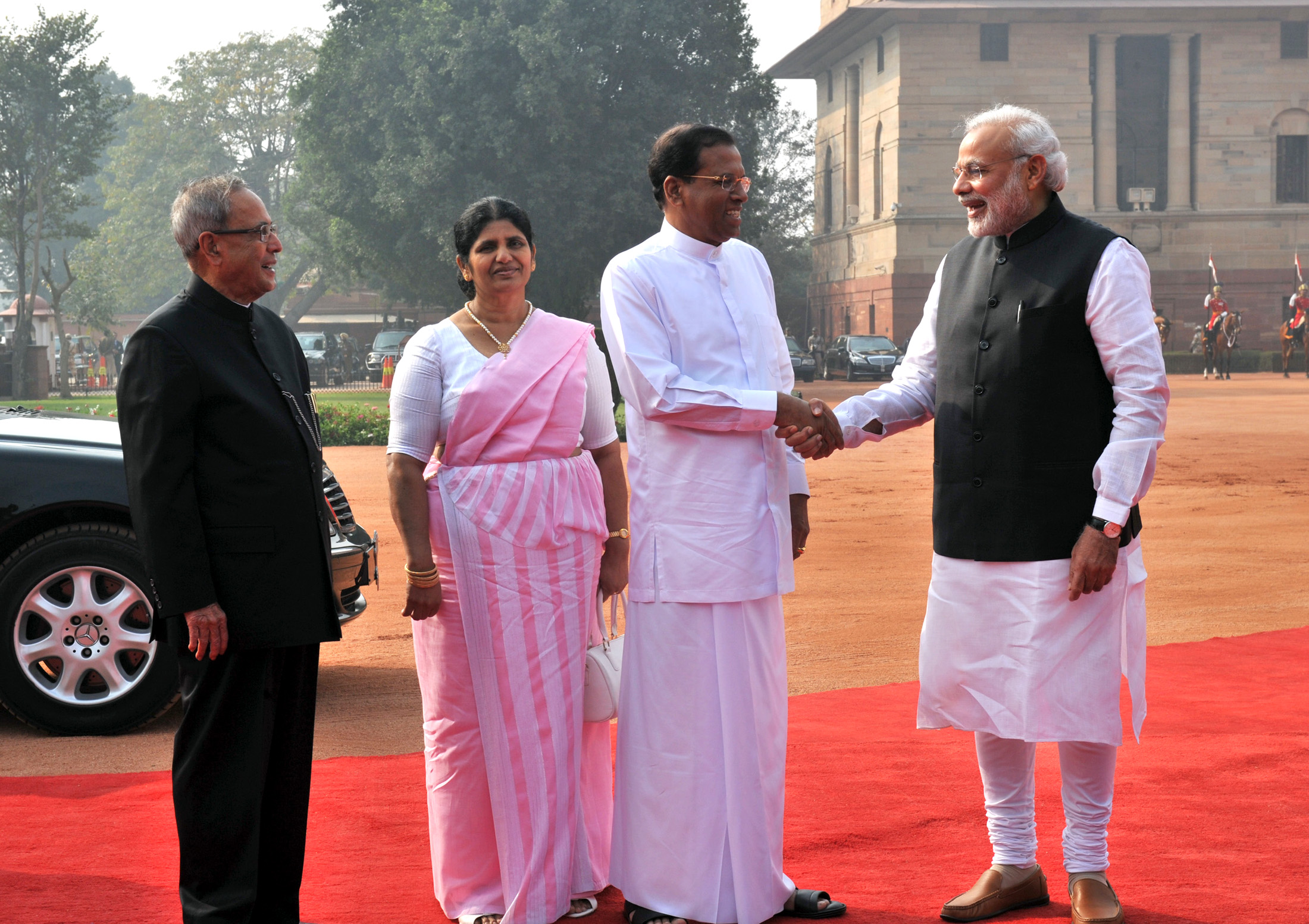 India's Prime Minister Narendra Modi shakes hands with Sri Lanka's  President Maithripala Sirisena during his welcome ceremony at the  Presidential Secretariat in Colombo