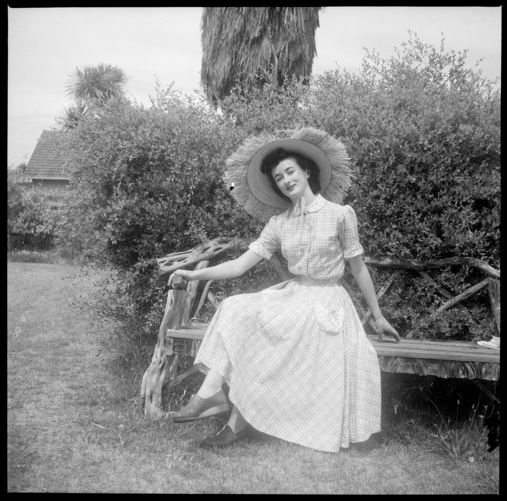 File:Woman wearing a large hat sitting on a garden bench 