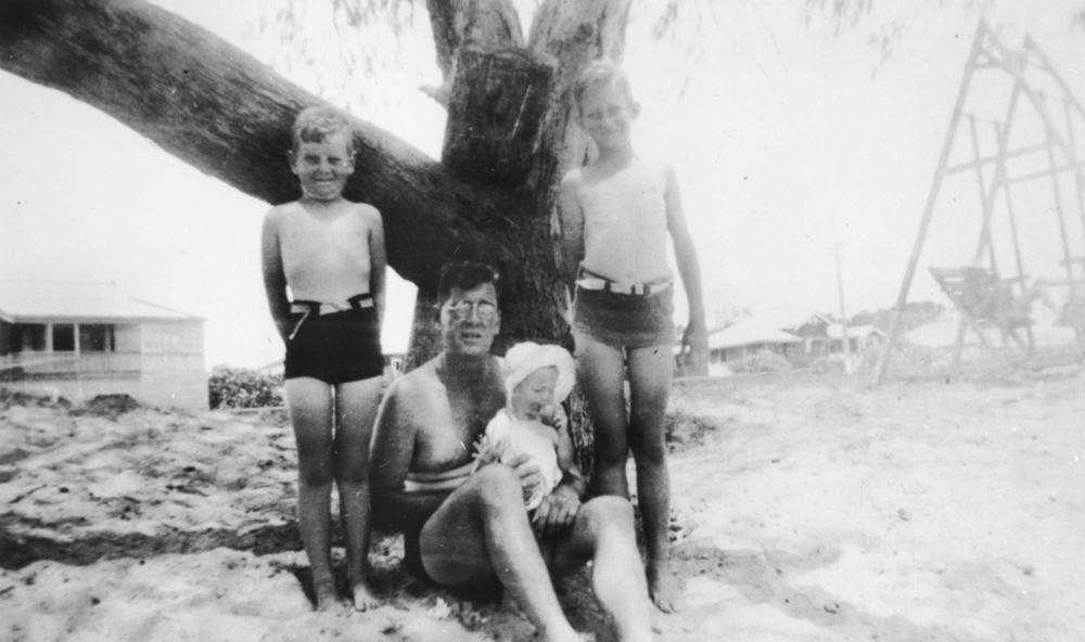 StateLibQld 2 120608 Family group posing on Bargara Beach%2C 1947