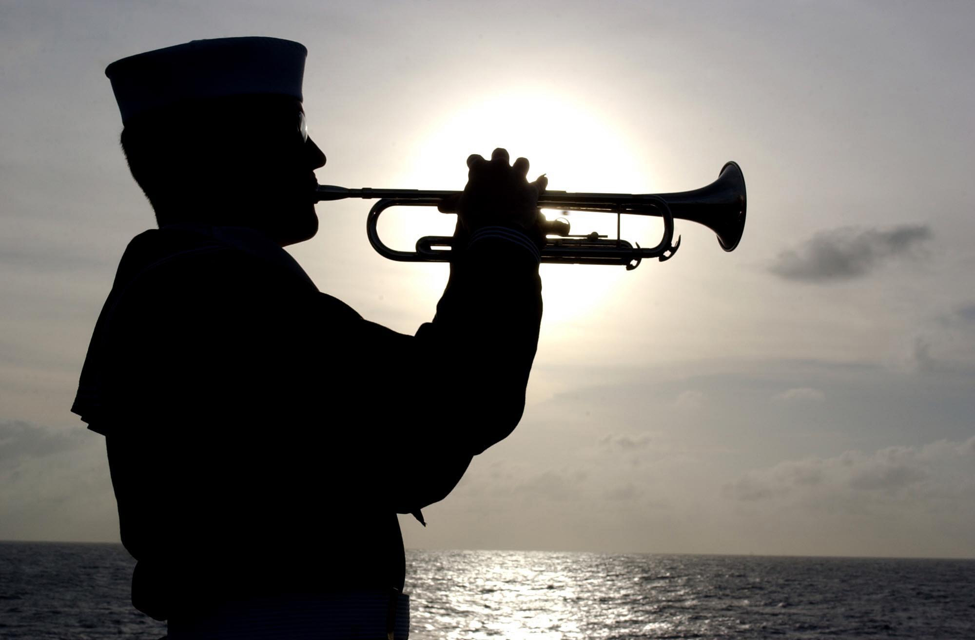 US Navy 030415-N-5555F-075 Machinist Mate 3rd Class Brian Walker plays TAPS...