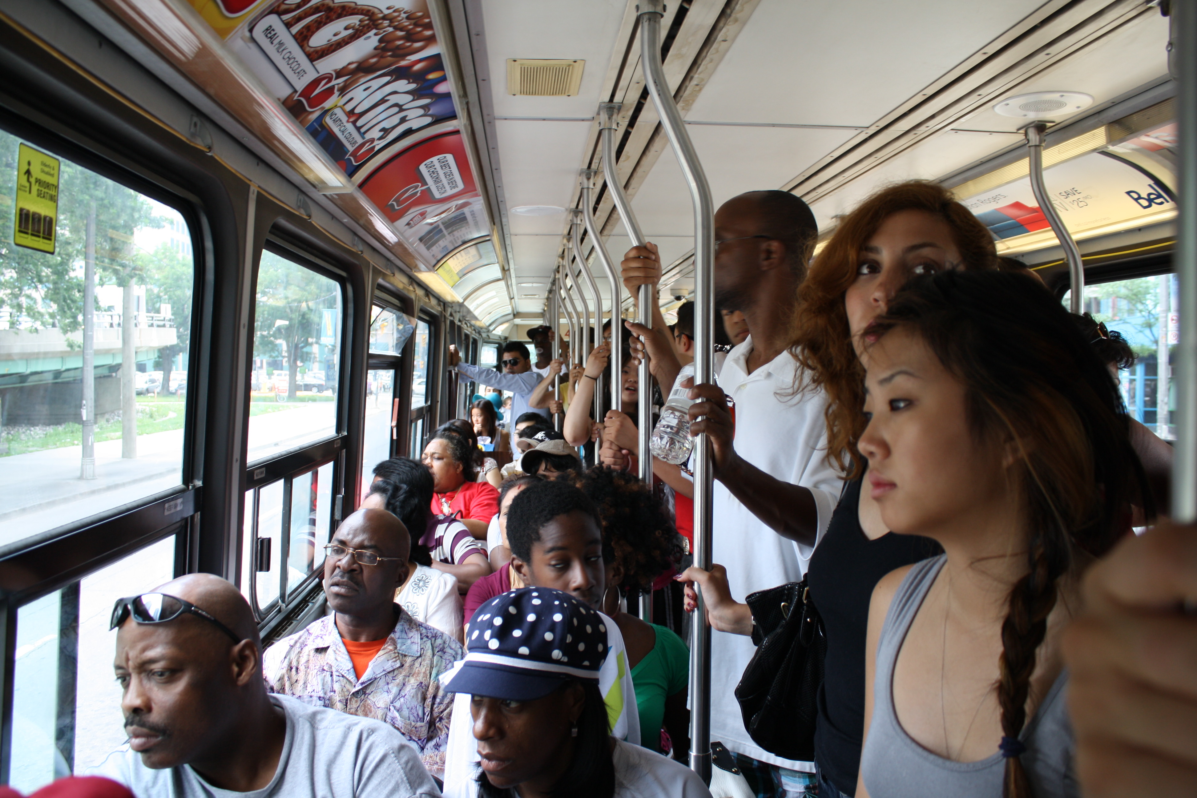 Public 19. Public transport crowd. Black women public transport Bus Handle photo.