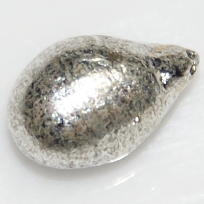 File:Tin drop, 1 gram, 7 mm long.jpg