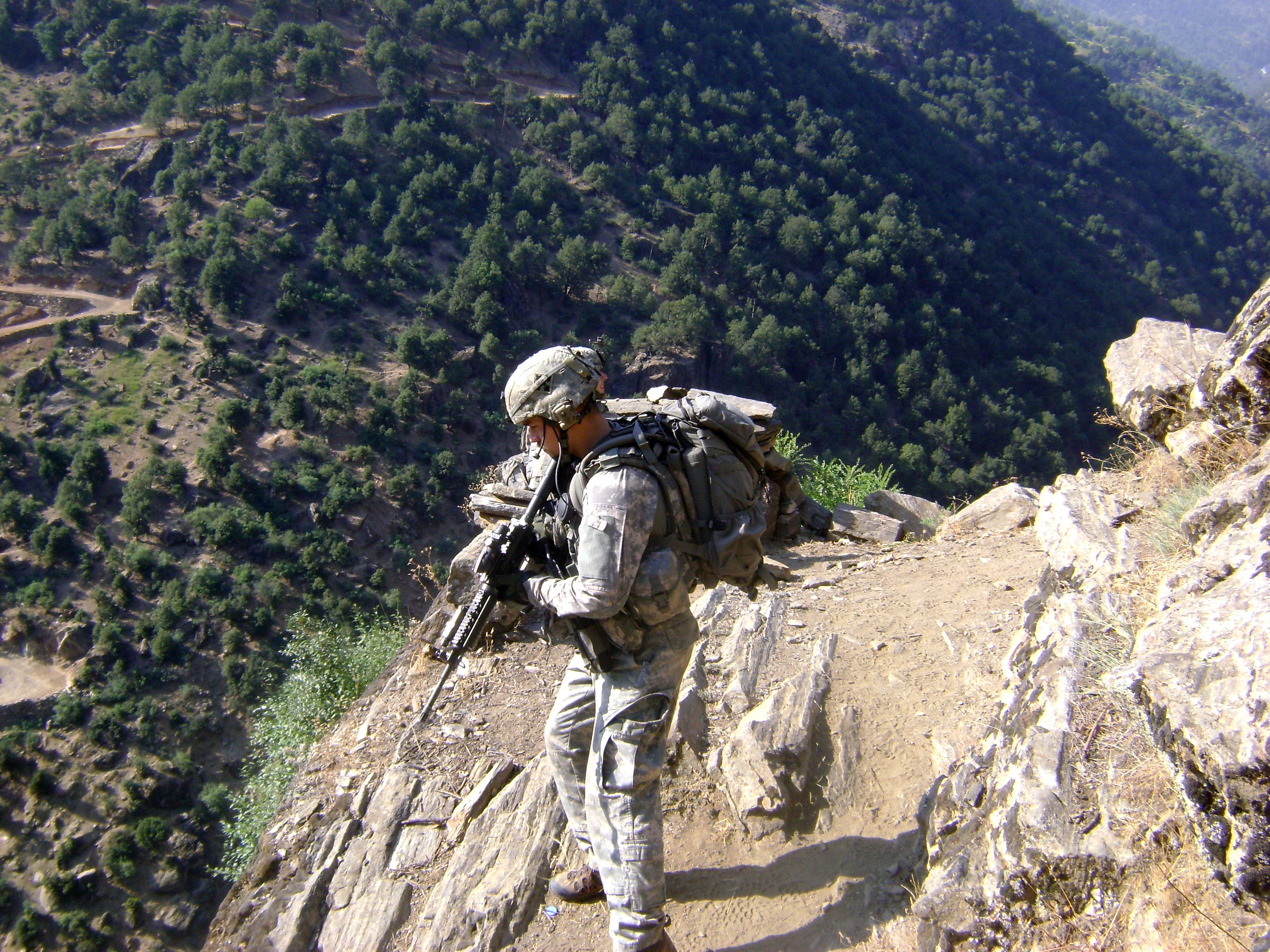 In this file photo dated July 27, 2009, U.S. Army Staff Sgt. Clinton L. Romesha patrols near Combat Outpost (COP) Keating in Kamdesh, Nuristan province, Afghanistan. Former Staff Sgt. Romesha was awarded the Medal of Honor Feb. 11, 2013, for actions during the Battle of Kamdesh at COP Keating, Nuristan province, Afghanistan, Oct. 3, 2009. Romesha was a section leader with Bravo Troop, 3rd Squadron, 61st Cavalry Regiment, 4th Brigade Combat Team, 4th Infantry Division at the time of the battle. (DoD photo/Released)