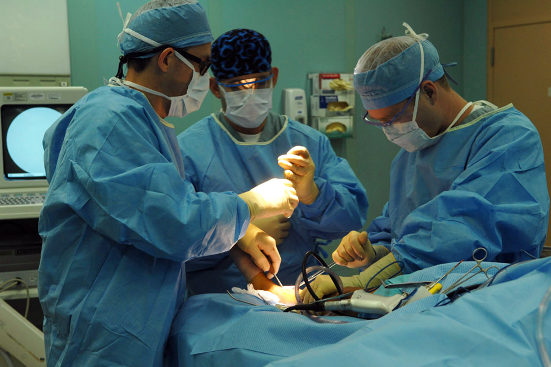 doctor removes a tumor from a young boy's leg