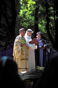 The Grand Druid of Brittany Gwenc'hlan Le Scouezec stands at the centre surrounded by the Archdruid of Wales and the Grand Bard of Cornwall, at the celebration of the hundredth anniversary of the Gorseth of Brittany in Hanvec, year 1999. GorseddDigorHanvec1.jpg