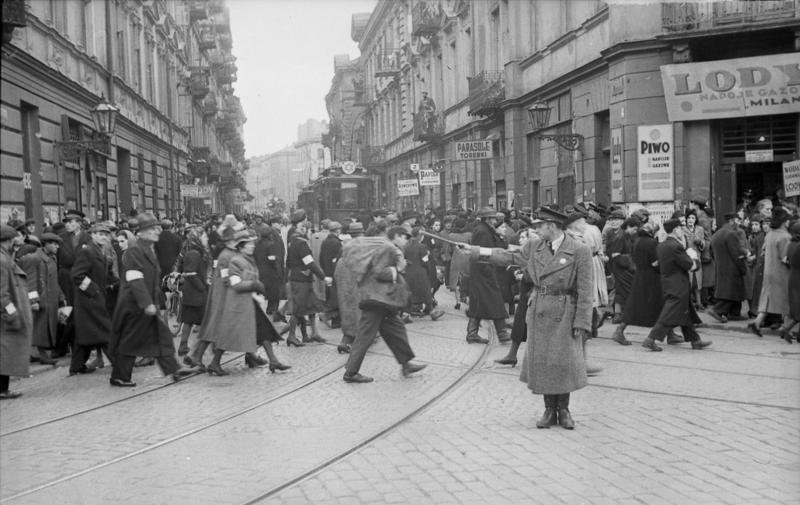 Polen, Warschauer Ghetto.- Angehöriger der Ghettopolizei auf einer Kreuzung den Verkehr regelnd, Passanten und Rikshas auf der Straße, 25.5.1941