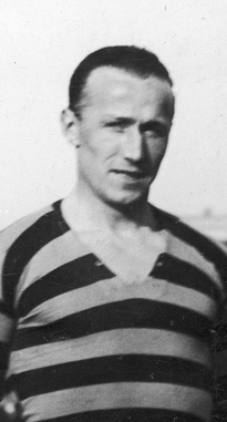 A profile shot of a young male athlete from the chest up, wearing a striped football shirt