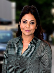 Shefali Shah smiling and looking at the camera.