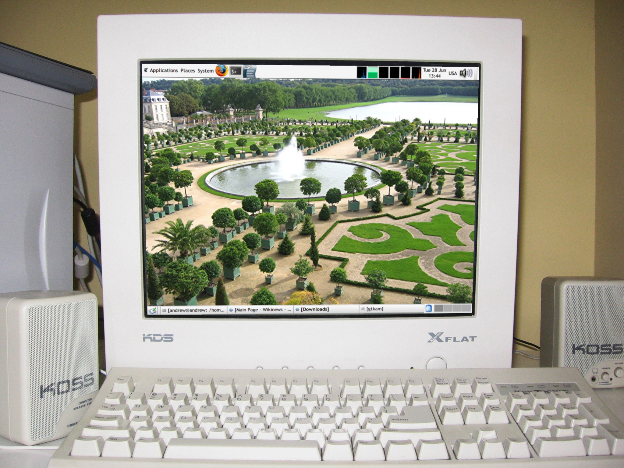 KDS XFlat computer monitor. Screen image simulated with the GIMP. Wallpaper in simulated screen image is a featured picture of the gardens of the Palace