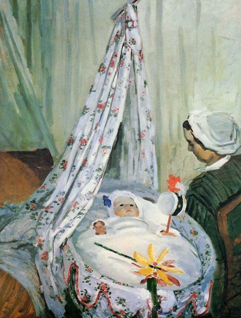 a baby in a cradle with a woman sitting beside the bassinet with a rattle