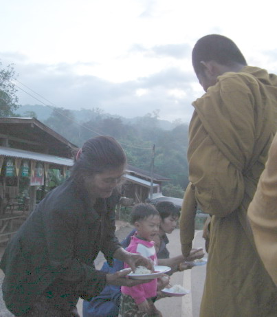 File:Monk takes to receive food from villagers.jpg