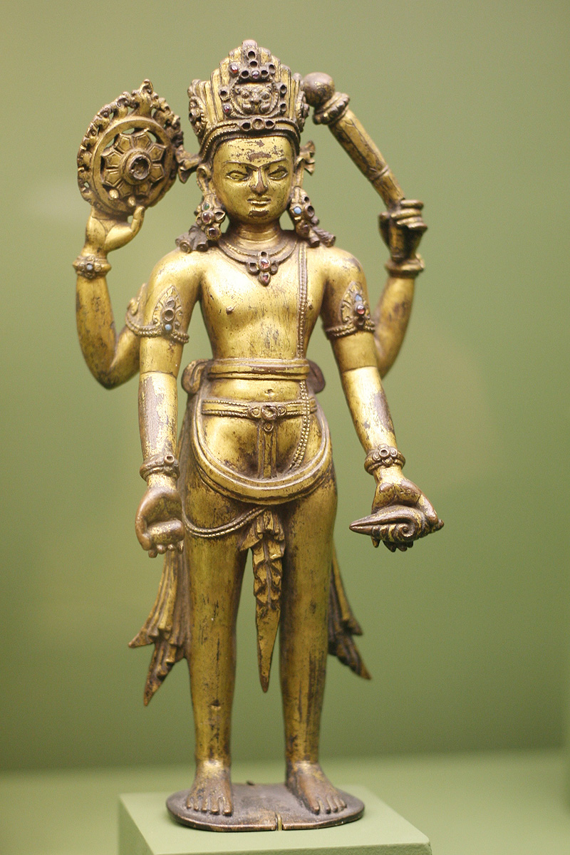 What does Vishnu hold in his hands?