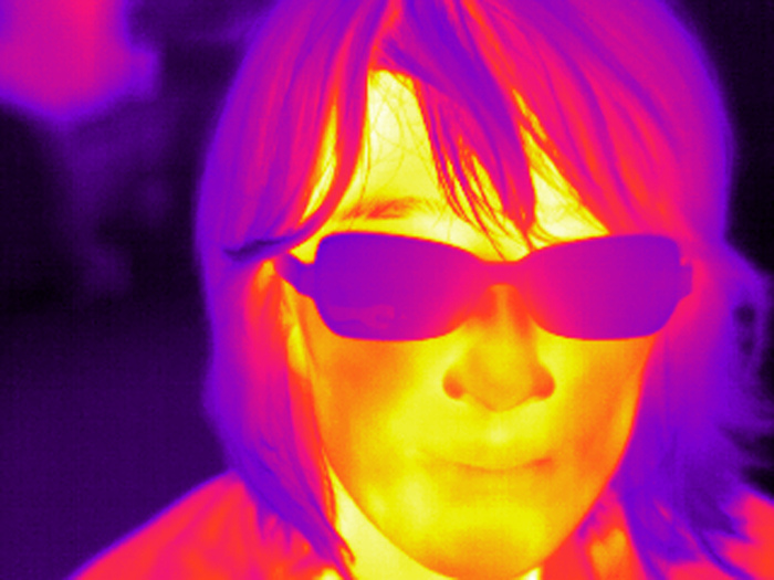 A thermal image of a woman’s face. This can be used to detect if someone has a fever.