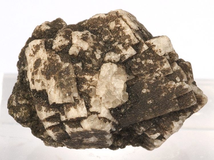 Anorthite crystals (white) in lava from Miyake Island, Japan (size: 2.4 x 1.7 x 1.7 cm)
