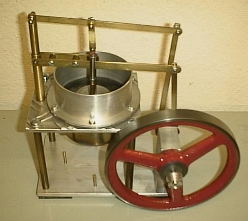 A model of a Stirling engine showing its simplicity.  Unlike the steam engine or internal combustion engine, it has no valves or timing train.  The heat source (not shown )  would be placed under the brass cylinder.