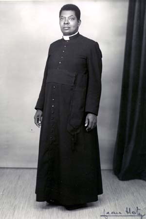 First native Roman Catholic parish priest from the Belgian Congo, wearing a Roman cassock with the standard 33 buttons. Early 1900s.