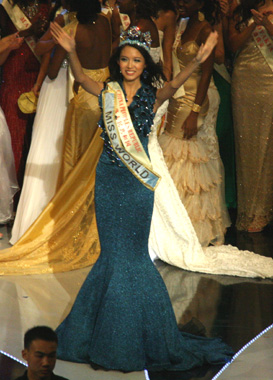 Winner of a beauty pageant wearing two sashes