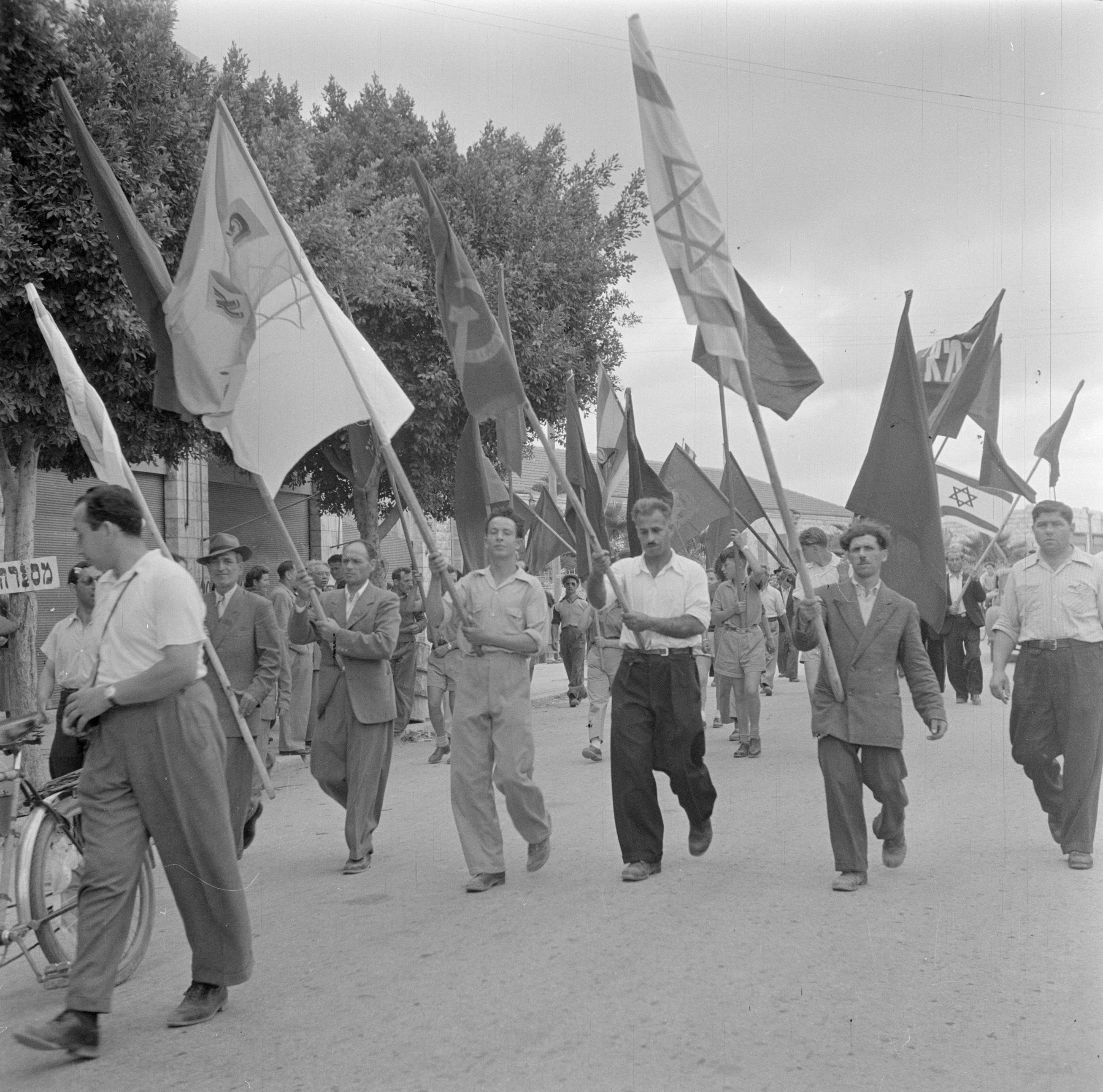 Deelnemers aan een 1 mei demonstratie (Dag van de Arbeid), zwaaiend met vlaggen, Bestanddeelnr 255-0168.jpg