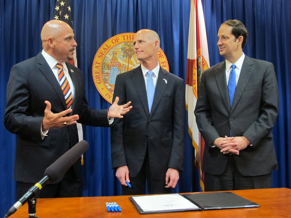 File:Governor Rick Scott, center, with legislators signing bill into law during the legislative session.jpg