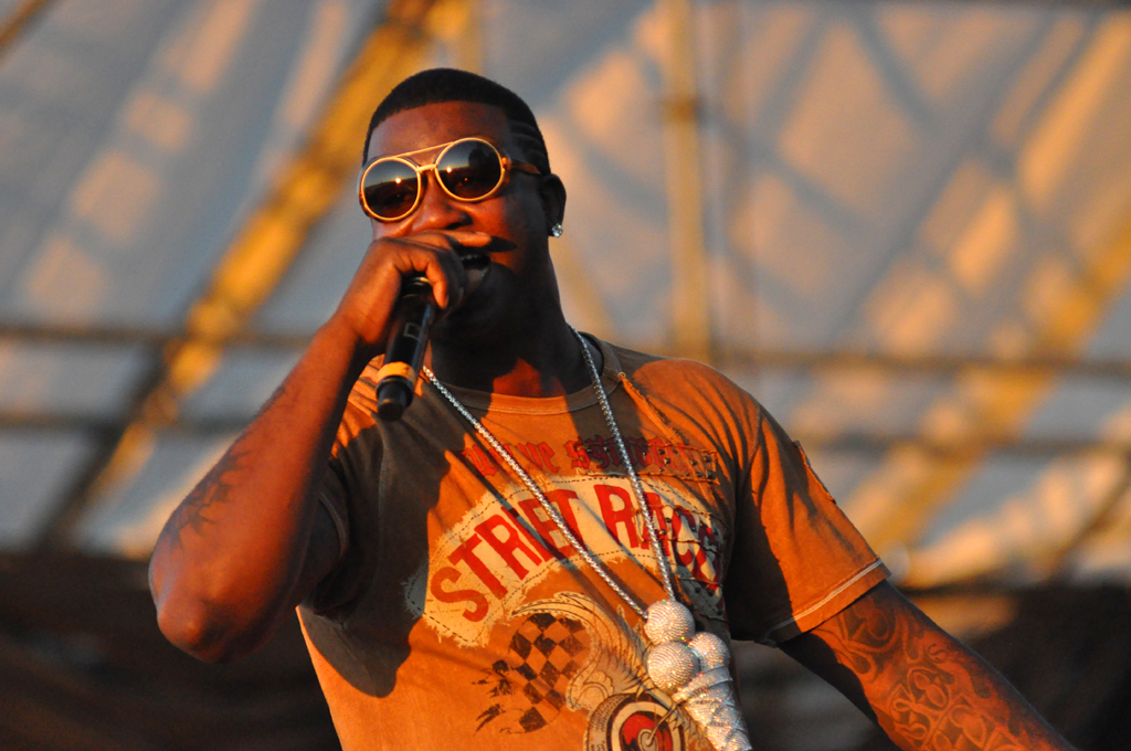 Davis performing in Williamsburg, Brooklyn, on August 29, 2010. He is rapping into his microphone.