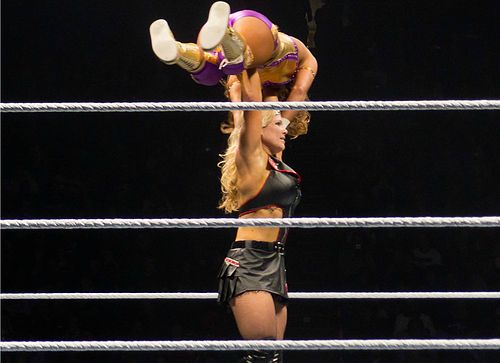 Beth Phoenix setting up a military press drop on Eve Torres