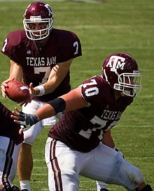 Wallace (right) defending quarterback Stephen McGee as a senior at Texas A&M. CodyWallace.jpg