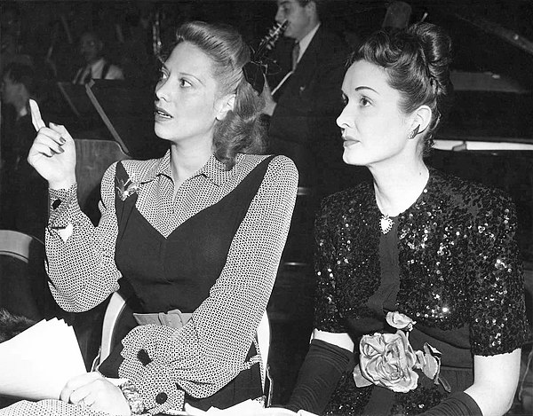 Dinah Shore and Gail Patrick in the CBS Radio studio at a rehearsal for "Belle of the Yukon" (February 12, 1945)