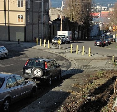 A diverter replaces a crossroads with two curves, forcing motor vehicles to turn
