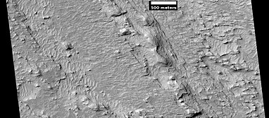 Layered features northeast of Gale Crater, as seen by HiRISE under HiWish program. Layers may be similar to the many layers that are being examined by the Curiosity rover.