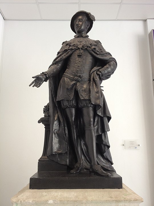A bronze statue of Edward VI. Edward wears Tudor dress.