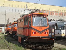 A custom-built snow removal tram in Bucharest. It uses a rotating brush to push the snow aside from the tracks. ITB 3VU snowplow tram in Victoria tram depot.jpg