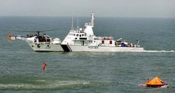 Indian Coast Guard Chetak Helicopter picking up survivors from water during a mock drill during SAREX 2014 (2).jpg