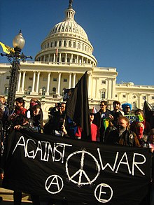 Anarchist anti-war protest in Washington DC J27 black bloc at US Capitol with black banner.jpg