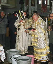 Polish Orthodox archbishop blessing the waters on the Eve of Theophany with a triple candlestick - "King Candles" Jordana1.jpg