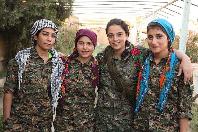 YPJ members in a greenhouse farm, for ecological cooperative farming in Rojava (AANES)