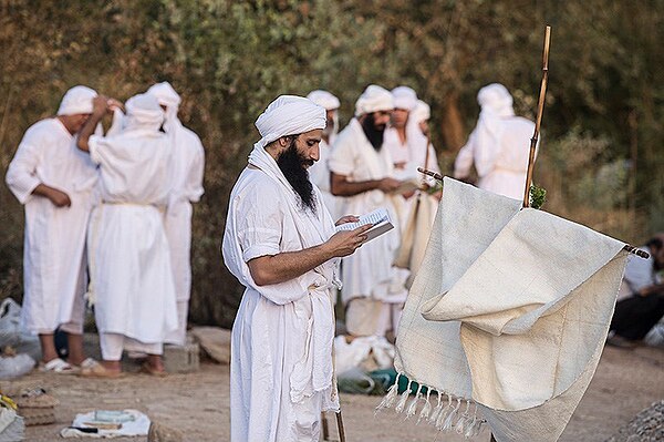 Mandaeans in prayer during baptism