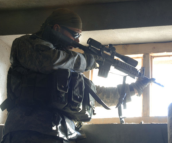 An American marksman looks for enemy activity along the hilltops near Dur Baba District, Afghanistan (2006)