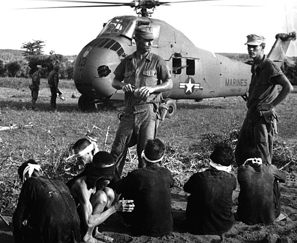 Vietcong prisoners (or civilians) await transport during Operation Starlite